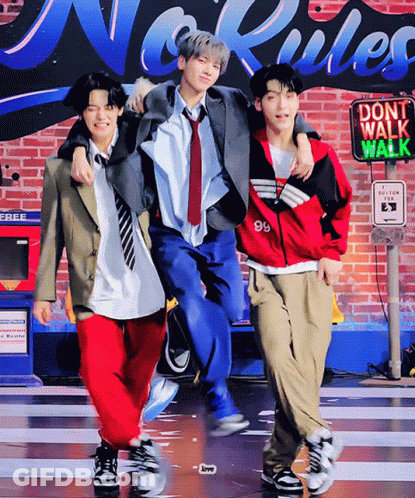 Three Young Men Posing In Front Of Do Not Walk Walk Sign GIF