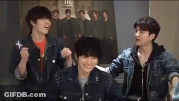 Three Young Men Sitting In Front Of Group Photo GIF