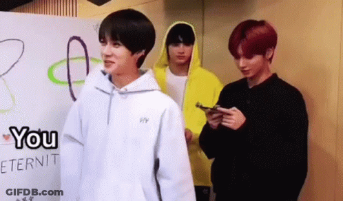 Three Young Men Standing In Front Of Wall GIF