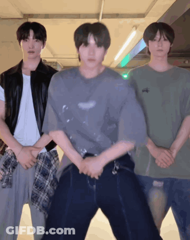 Three Young Men Standing Next To Each Other One Of Whom Is Wearing A T-Shirt That Says ' Abercrombie ' GIF
