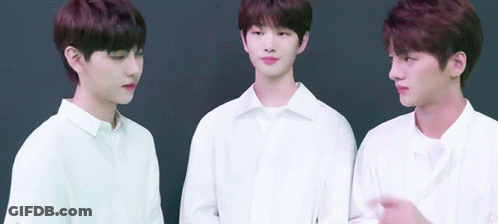 Three Young Men Wearing White Shirts Are Standing Next To Each Other GIF