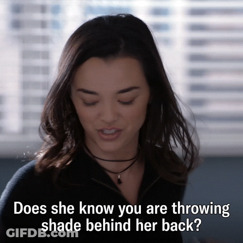 Throwing Shady Behind Her Back GIF