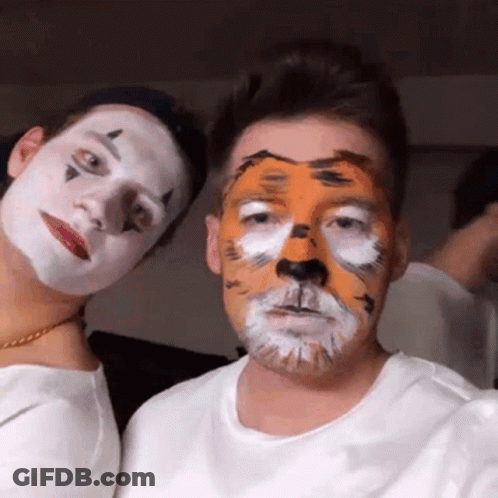 Tiger Face Man Next To Clown Face Man GIF