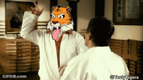 Tiger Head On Yellow And Purple Background GIF