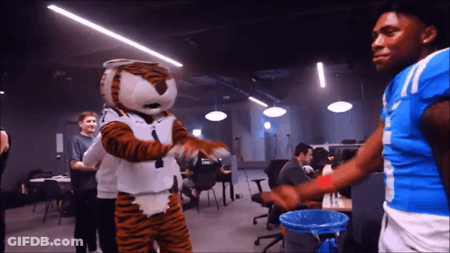 Tiger Mascot Dancing With Man In Blue Shirt Number 11 GIF