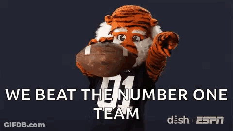 Tiger Mascot Holding Football Saying We Beat The Number One Team GIF