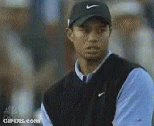 Tiger Woods Is Wearing A Black Nike Hat And A Blue Shirt GIF