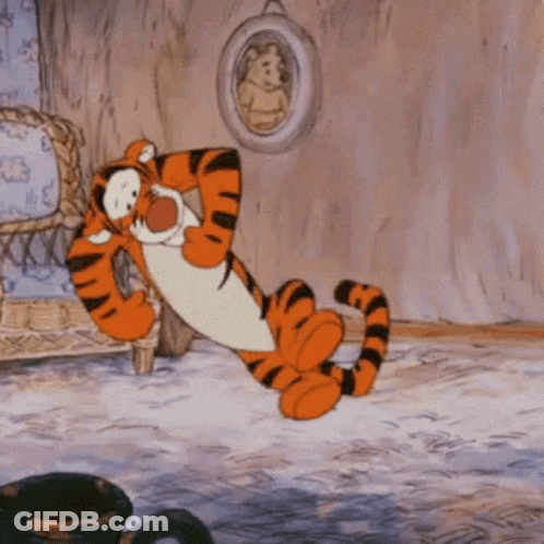 Tigger From Winnie The Pooh Is Laying Down In A Living Room GIF