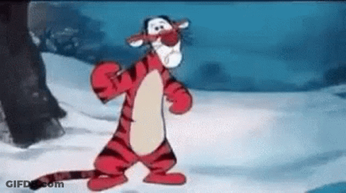 Tigger From Winnie The Pooh Is Standing In The Snow Wearing A Mask . GIF