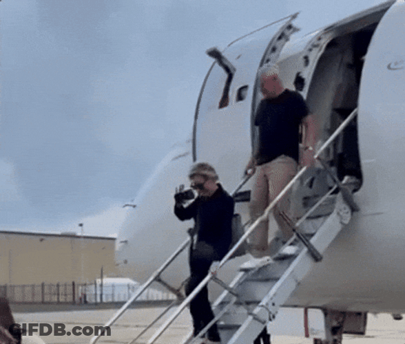 Tim Walz Going Down The Airplane GIF