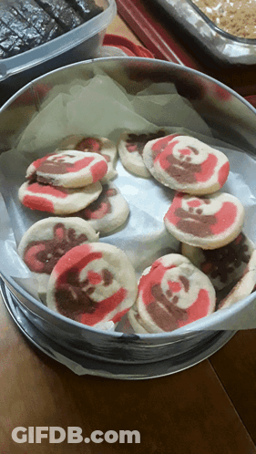 Tin Of Red And White Swirl Cookies GIF