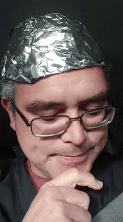 Tinfoil Hat Talking On Conspiracy GIF