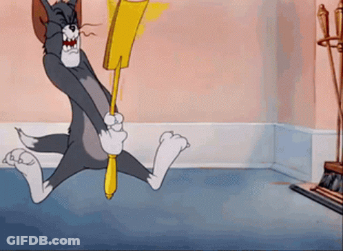Tom And Jerry Holding Broom In Room GIF