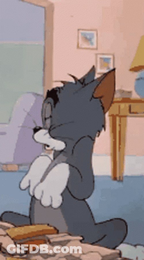Tom Cat Grinning And Hiding Paws GIF