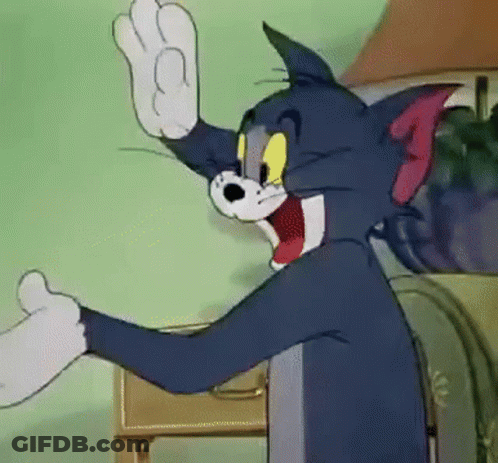 Tom From The Cartoon Tom And Jerry Is Waving His Hand In A Room . GIF