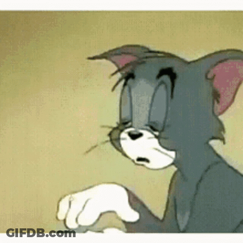 Tom From Tom And Jerry Is Sitting Down With His Eyes Closed . GIF