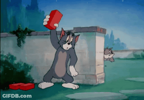 Tom Holding Red Brick While Another Cat Looks On GIF