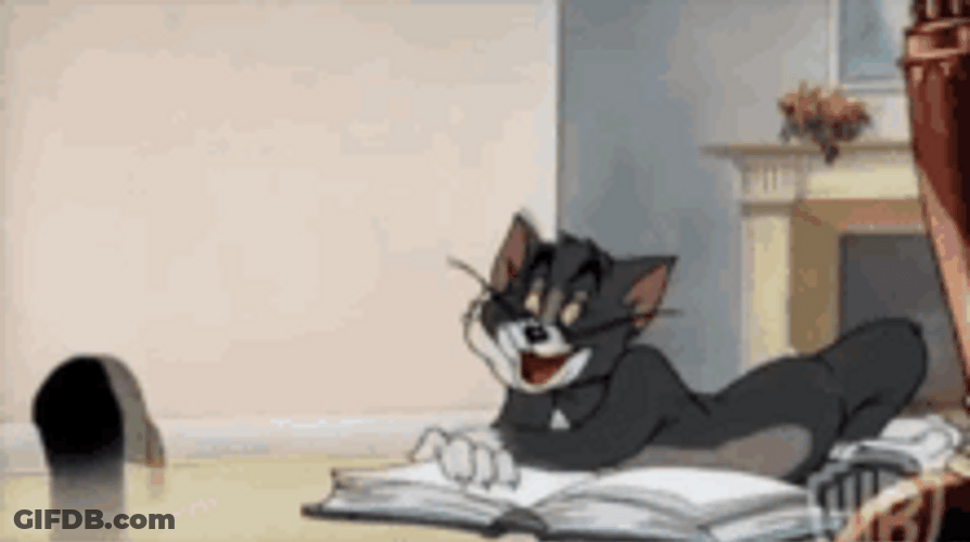 Tom Laughing Reading Book GIF
