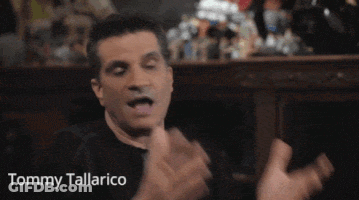 Tommy Tallarico In Black Hat With Crossbones Logo GIF