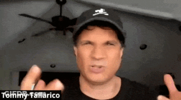 Tommy Tallarico In Black Hat With Crossbones Logo GIF