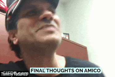 Tommy Tallarico Is Wearing A Black Shirt And A Hat GIF