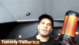 Tommy Tallarico Standing In Front Of Microphone In Dark Room GIF