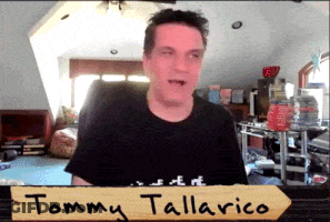 Tommy Tallarico Standing In Front Of Sign GIF