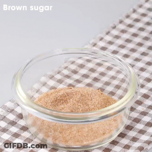 Tongs Stirring Brown Sugar In Glass Bowl GIF