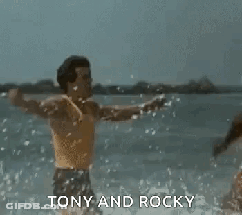 Tony And Rocky Men Arms Outstretched In Water GIF