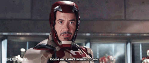 Tony Stark Is Wearing A Helmet And Saying Come On I Ain 'T Scared Of You . GIF