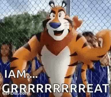 Tony The Tiger Standing In Front Of Chain Link Fence GIF