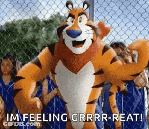 Tony The Tiger Standing In Front Of Chain Link Fence With People Behind GIF