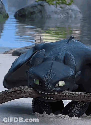 Toothless From How To Train Your Dragon Is Laying On The Ground GIF