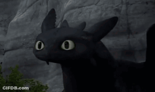 Toothless From How To Train Your Dragon Is Looking At The Camera With His Eyes Glowing . GIF