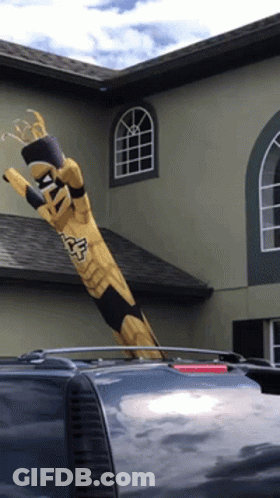 Totem Pole Saying Fox Blowing In Wind GIF