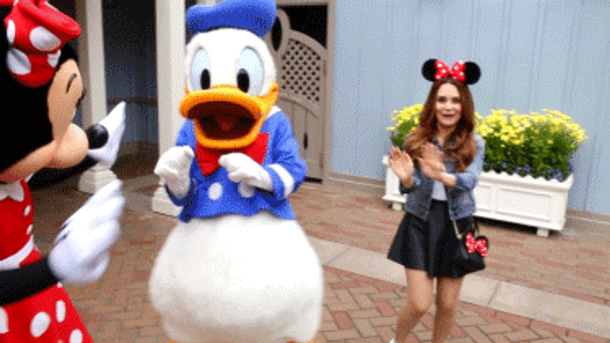 Tourist Happily Dancing With Donald Duck In Disneyland GIF