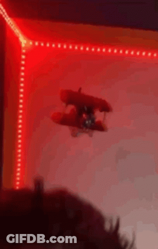 Toy Airplane Flying Through Red Light GIF