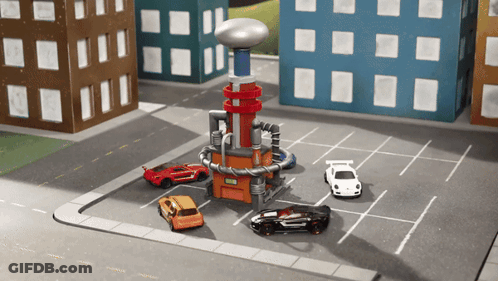 Toy Cars Are Parked In A Parking Lot Next To A Building GIF