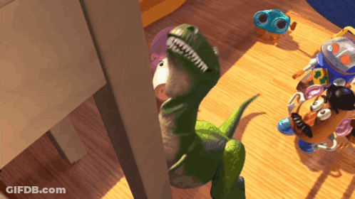 Toy Dinosaur Next To Mr Potato Head GIF