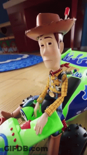 Toy Story Character Sitting In Green Vehicle GIF