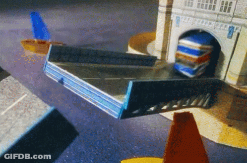 Toy Truck Driving Through Tunnel Under Tower GIF