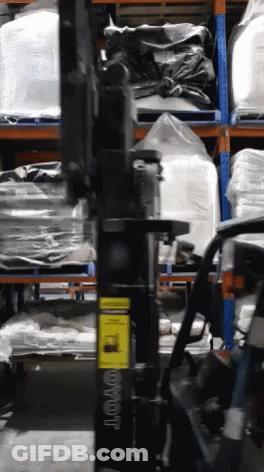 Toyota Forklift In Warehouse With Bags On Shelves GIF
