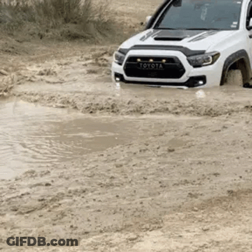 Toyota Tacoma Driving Through Muddy Puddle GIF