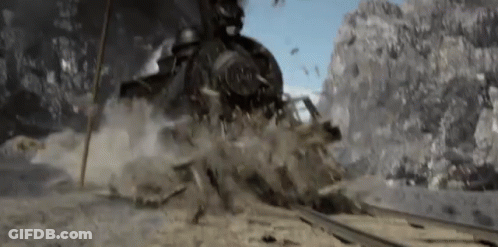 Train Going Down Tracks In Mountain Range GIF