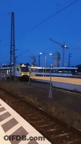 Train Pulling Into Station With H Sign GIF