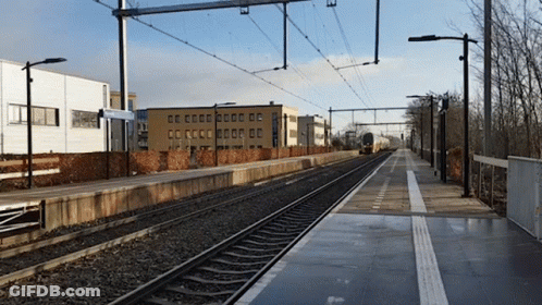Train Track With Building And CC Sign GIF