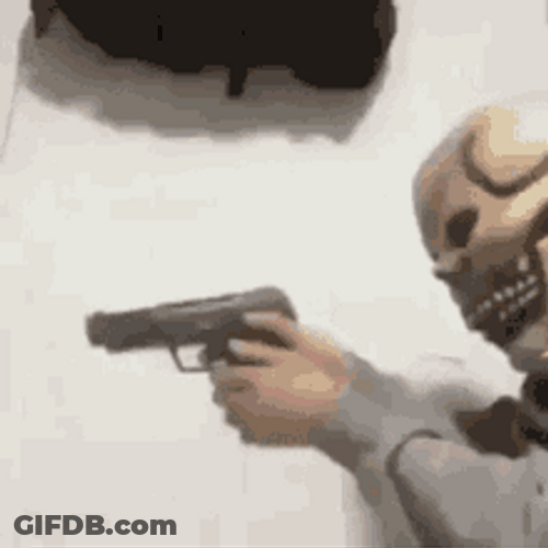 Trained Mask Guy Firing A Gun GIF