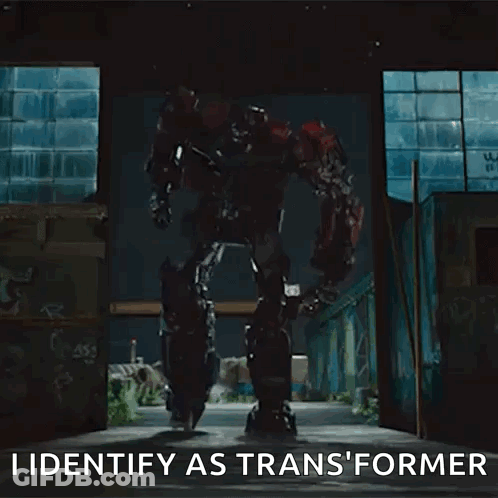 Transformer Robot Standing In Dark Room Says I Identify As Transformer GIF