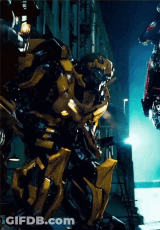 Transformer Standing In Front Of Building At Night GIF