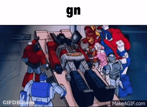 Transformers Gathered Around Table With GN Above Them GIF